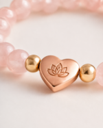Close up of rose gold lotus heart charm on Rose Quartz Love Bracelet
