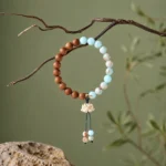 Sandalwood Lotus Bracelet by AVENSU on white background