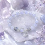 Celestial blue planet charm bracelet displayed on lavender crystal clusters