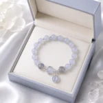 Celestial blue planet charm bracelet displayed in an open lavender jewelry gift box