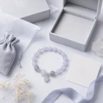 Celestial blue planet charm bracelet with jewelry box pouch and gift card flat lay