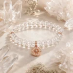 Clear quartz clarity and focus bracelet with rose gold star charm styled among natural quartz crystals