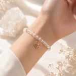 Clear quartz clarity and focus bracelet with rose gold star charm worn on wrist