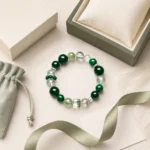 Emerald green mixed crystal bracelet packaging flat lay with gift box and pouch