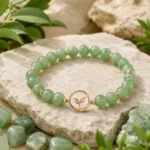 Green aventurine growth and renewal bracelet with leaf charm styled with raw green crystals and natural leaves