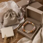 Mixed jasper grounding and balance bracelet displayed in a taupe gift box with velvet pouch
