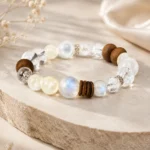 Mixed stone wood and crystal bead bracelet displayed on a neutral stone platform