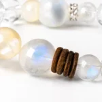Close-up of translucent crystal beads and natural brown wood spacers on a mixed bead bracelet