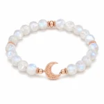 Moonstone intuition and calm bracelet with rose gold crescent moon charm on white background