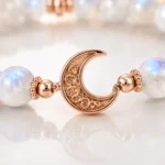 Close-up of moonstone intuition and new beginnings bracelet with rose gold crescent moon charm