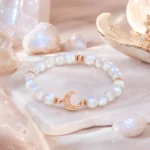 Moonstone intuition and new beginnings bracelet with rose gold crescent moon charm among luminous crystals