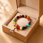 Multicolor gemstone and natural seed bead bracelet displayed in an open beige jewelry gift box