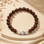 Natural dark wood bead bracelet with three blue gemstone accent beads and gold-tone spacers