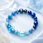 Ocean blue mixed crystal bead bracelet with faceted aqua centerpiece on an icy blue background