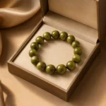 Olive green wood bead bracelet displayed in an open brown jewelry gift box