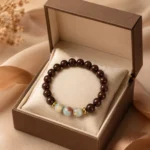 Brown wood and blue gemstone bracelet displayed in an open luxury gift box with soft cushion