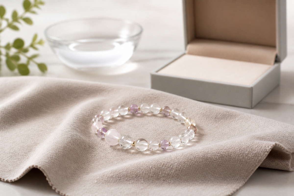Crystal bead bracelet on a soft microfiber cloth beside an open jewelry box