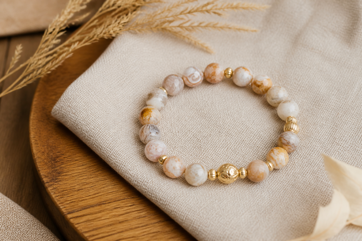 Crazy lace agate bracelet on sand linen and warm wood