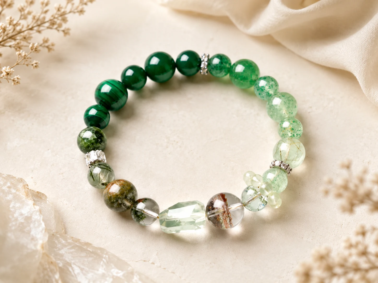 Scorpio transformation bracelet with dark emerald beads, pale green crystal accents, inclusion stones, silver spacers, and a faceted centerpiece