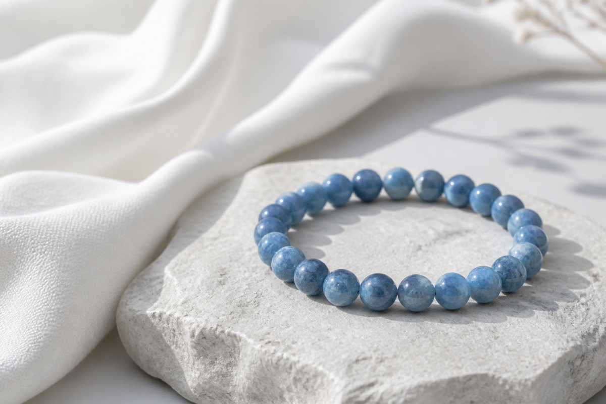 Blue aventurine bead bracelet on pale grey stone and white cotton