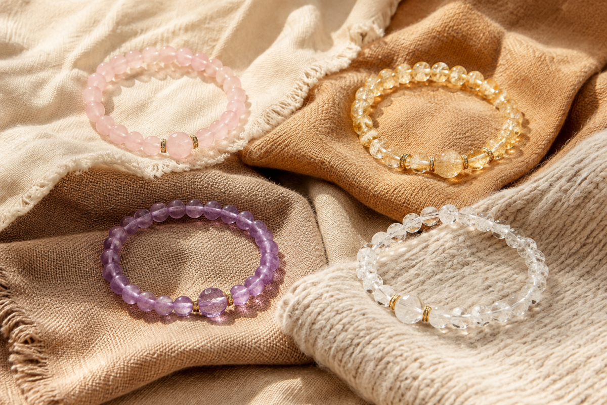 Four crystal bracelets on neutral and warm fabric swatches for a seasonal wardrobe