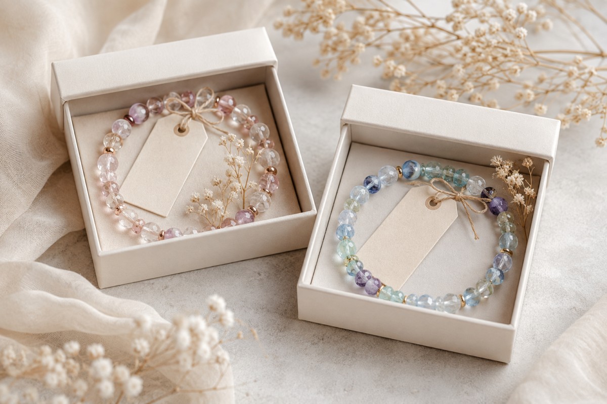 Two crystal bead bracelets in cream gift boxes with blank tags and dried flowers